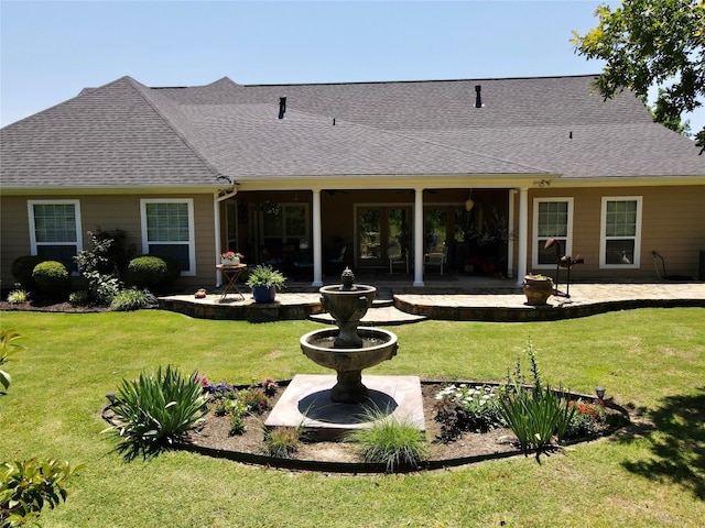 back of house featuring a patio area and a yard