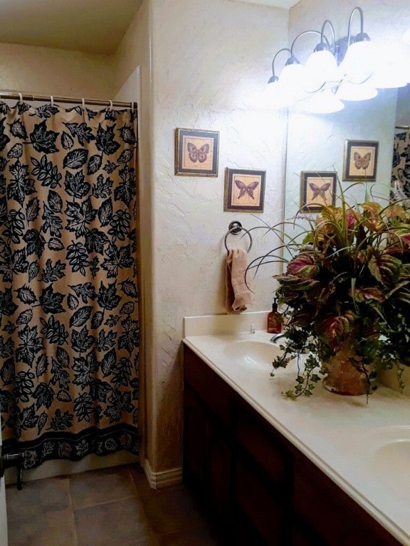 bathroom with vanity with extensive cabinet space and tile flooring