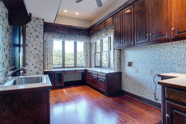 interior space with sink, cabinets, washer hookup, ceiling fan, and light hardwood / wood-style floors