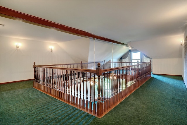 hall with dark carpet and lofted ceiling with beams