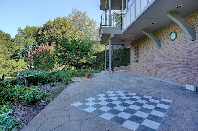 view of patio / terrace with ceiling fan and a balcony