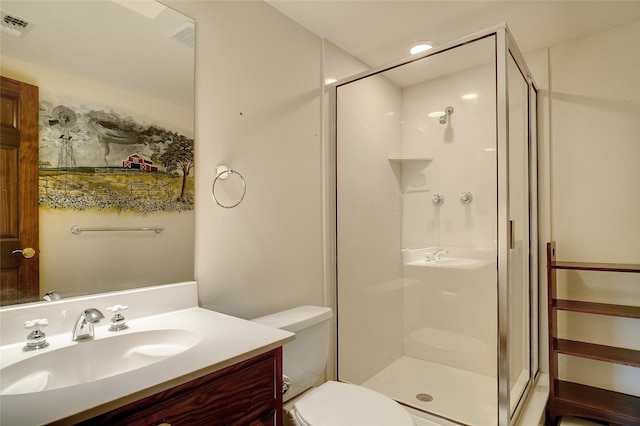 bathroom featuring vanity, toilet, and a shower with door