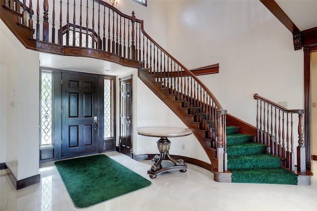 entrance foyer featuring a towering ceiling