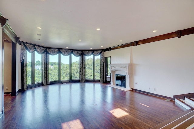 unfurnished living room featuring dark wood-type flooring and a fireplace