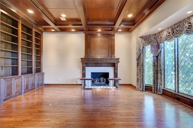 unfurnished living room with coffered ceiling, built in shelves, crown molding, and a large fireplace