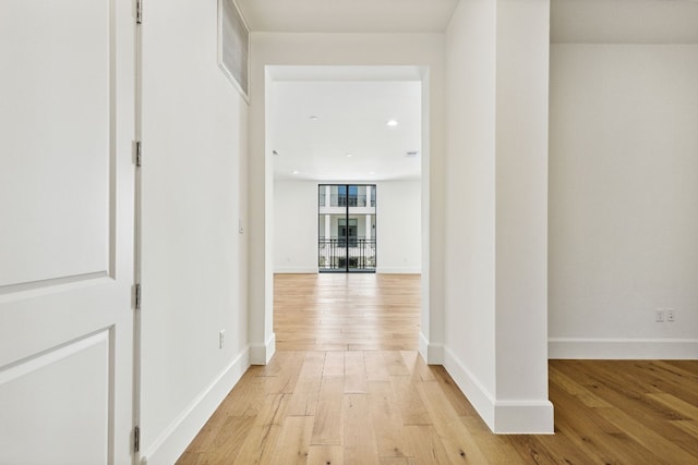 corridor with light hardwood / wood-style flooring