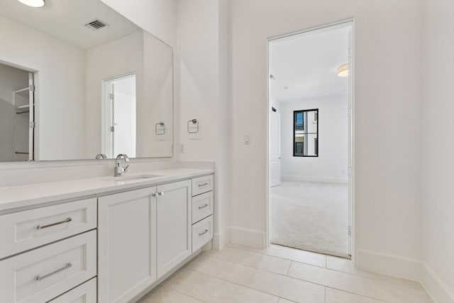 bathroom featuring tile floors and vanity