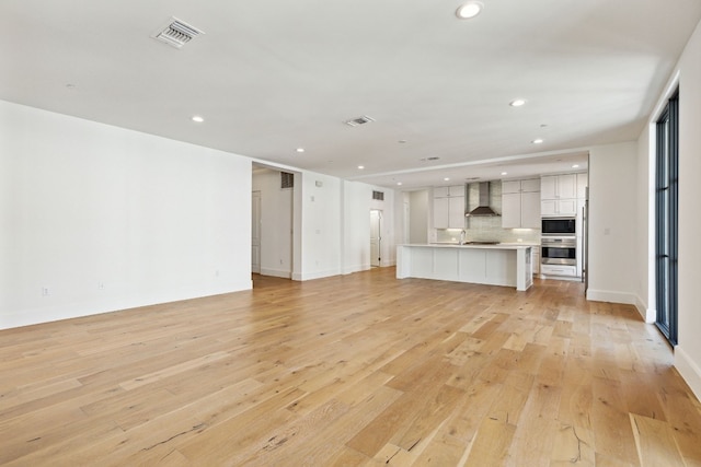 unfurnished living room featuring light wood-type flooring