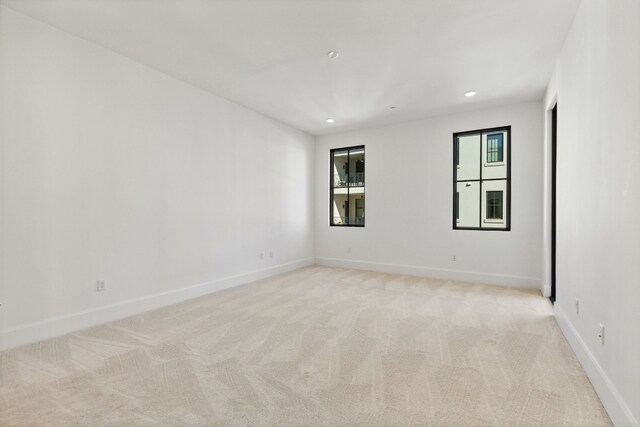 unfurnished room with light colored carpet