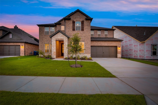 view of front of property featuring a yard and a garage