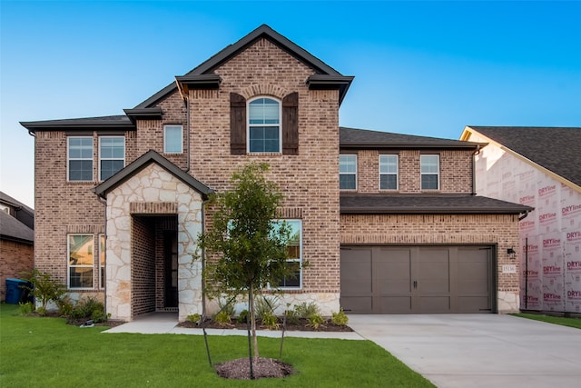 view of front of property with a garage and a front yard