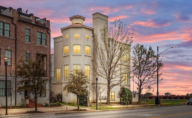 view of outdoor building at dusk