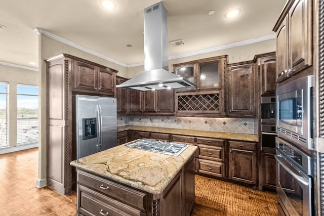 kitchen with island exhaust hood, a kitchen island, stainless steel appliances, tasteful backsplash, and hardwood / wood-style flooring