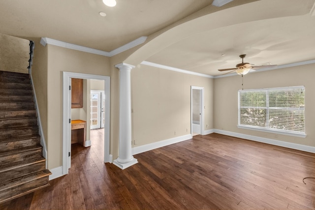 spare room featuring dark hardwood / wood-style floors, ornamental molding, ceiling fan, and ornate columns