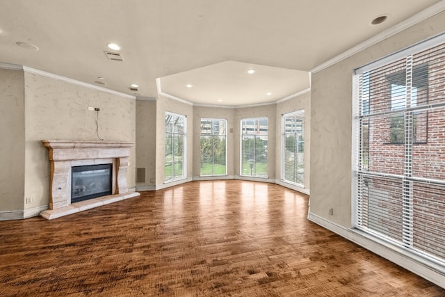 unfurnished living room featuring ornamental molding and light wood-type flooring