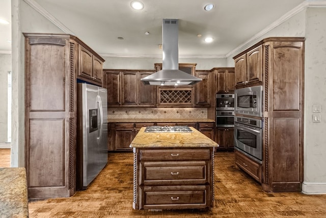 kitchen featuring dark hardwood / wood-style floors, island exhaust hood, a kitchen island, appliances with stainless steel finishes, and backsplash