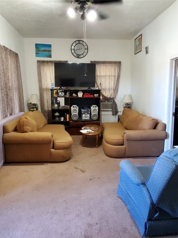 living room with ceiling fan and carpet