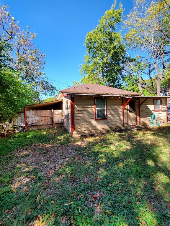 view of side of home with a yard