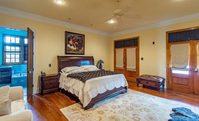 bedroom with crown molding, dark hardwood / wood-style floors, connected bathroom, and ceiling fan