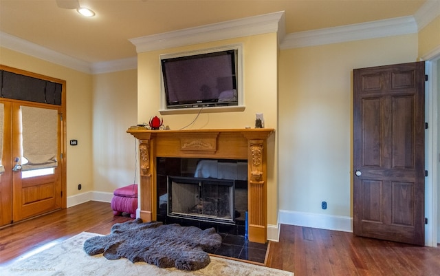 living room featuring french doors, ornamental molding, dark wood-type flooring, and a fireplace