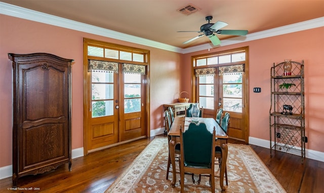 dining room with dark wood-type flooring, french doors, plenty of natural light, ceiling fan, and ornamental molding