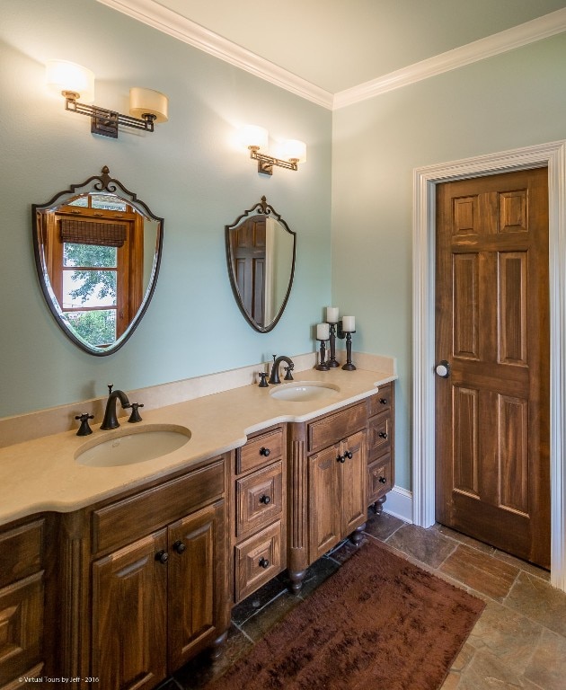 bathroom featuring dual bowl vanity, crown molding, and tile floors