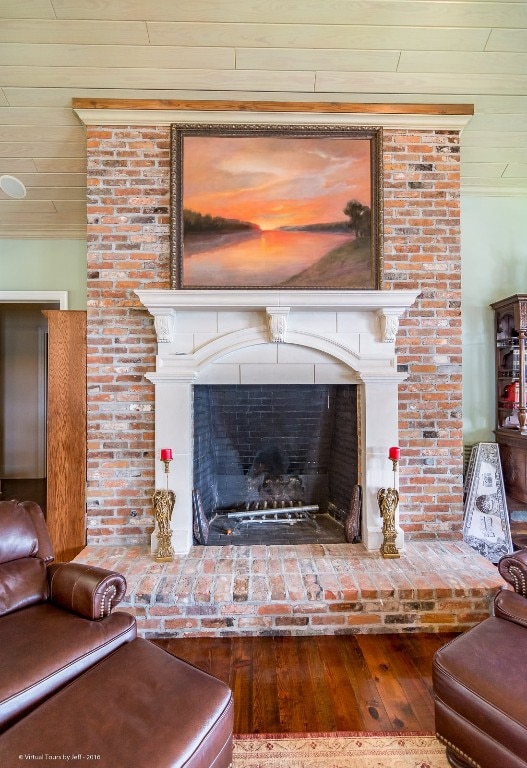 room details featuring ornamental molding, hardwood / wood-style floors, and a brick fireplace