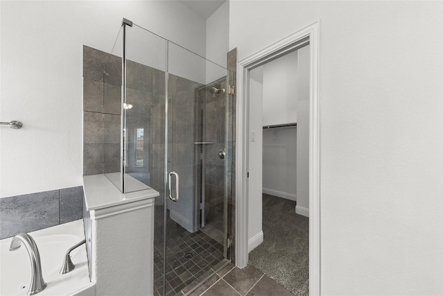 bathroom featuring an enclosed shower and tile floors