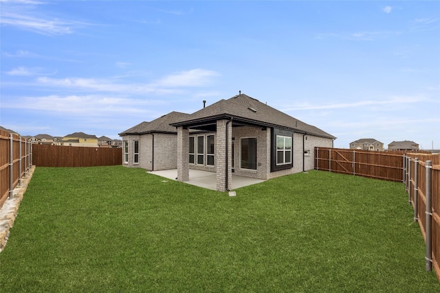 back of house featuring a lawn and a patio