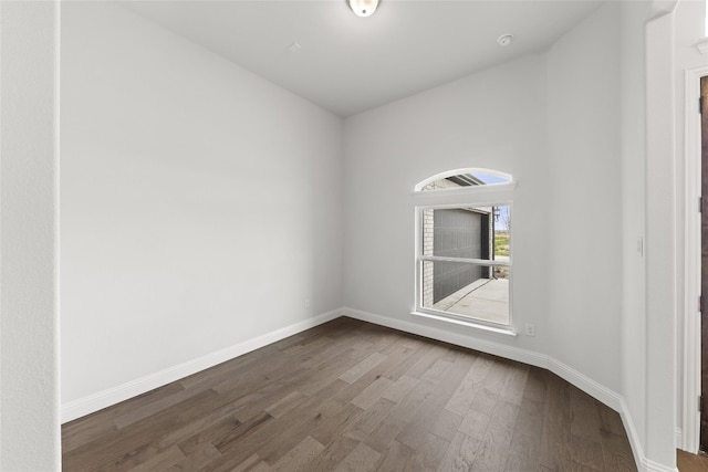 empty room featuring dark hardwood / wood-style flooring