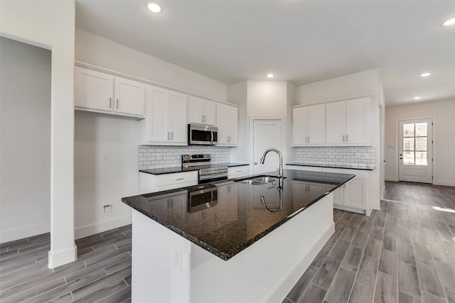 kitchen with sink, white cabinets, and appliances with stainless steel finishes