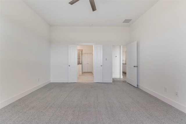 unfurnished bedroom featuring ceiling fan and light colored carpet