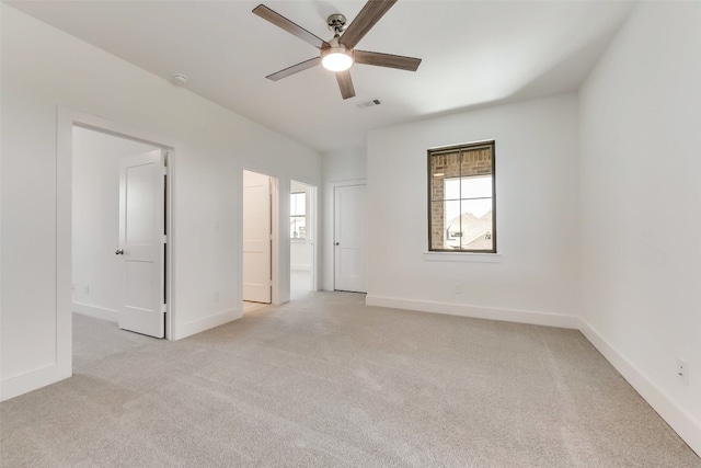 unfurnished room featuring light colored carpet and ceiling fan