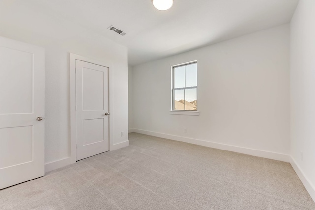 unfurnished bedroom with light colored carpet