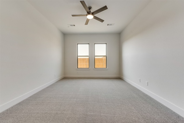 empty room with light colored carpet and ceiling fan