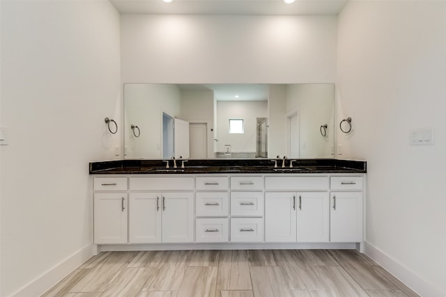 bathroom featuring vanity and an enclosed shower