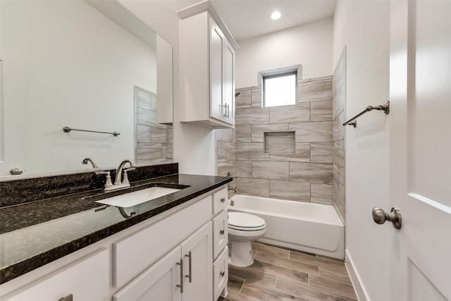 full bathroom with vanity, toilet, and tiled shower / bath