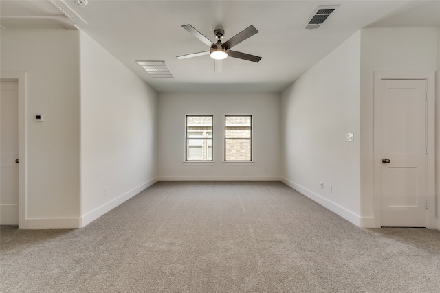 carpeted spare room with ceiling fan