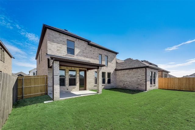 rear view of property with a patio area and a yard