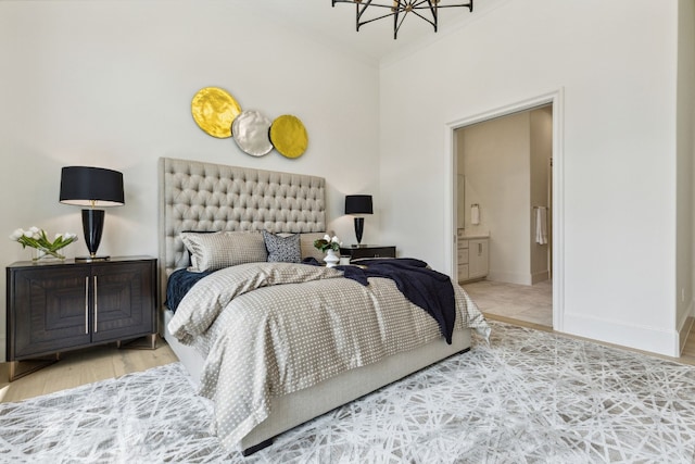 bedroom with an inviting chandelier and ensuite bathroom