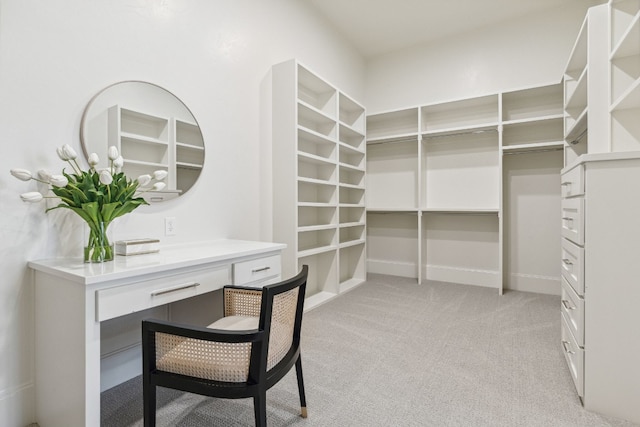 walk in closet featuring light carpet