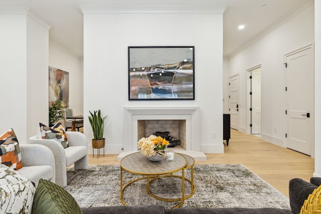 living room featuring light hardwood / wood-style flooring and ornamental molding