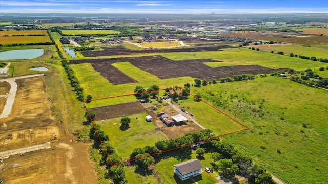 birds eye view of property with a rural view