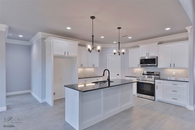 kitchen with a notable chandelier, stainless steel appliances, white cabinetry, and hanging light fixtures