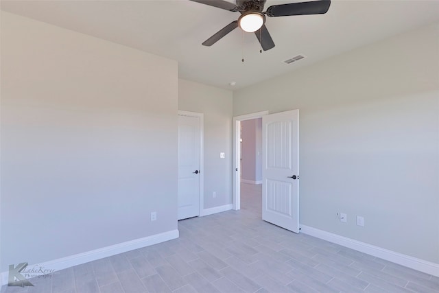 empty room with light wood-type flooring and ceiling fan