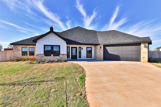 view of front of house featuring a front yard and a garage