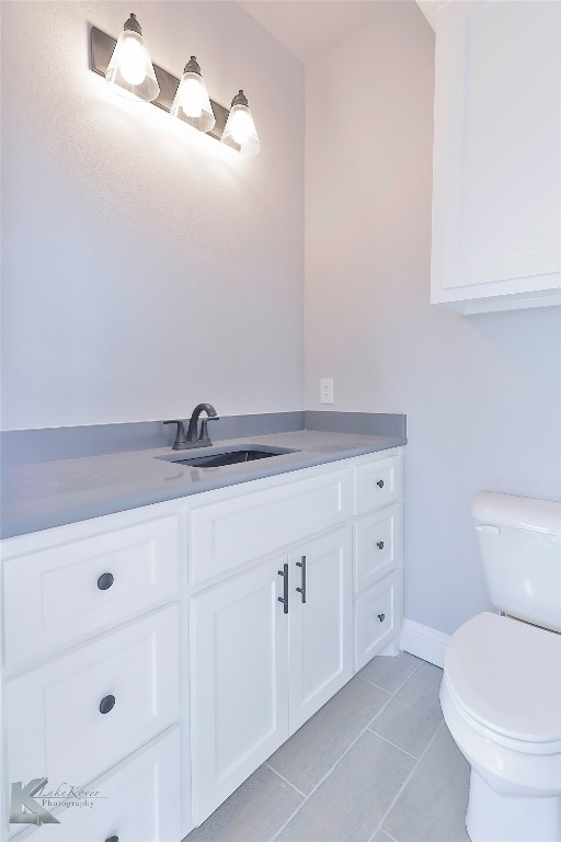 bathroom featuring vanity, toilet, and tile patterned floors