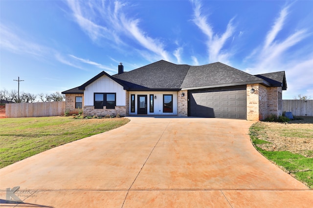 view of front of property featuring a front yard and a garage