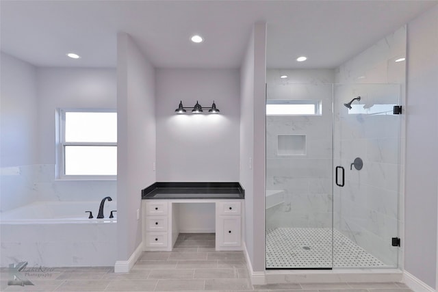 bathroom with independent shower and bath and vanity