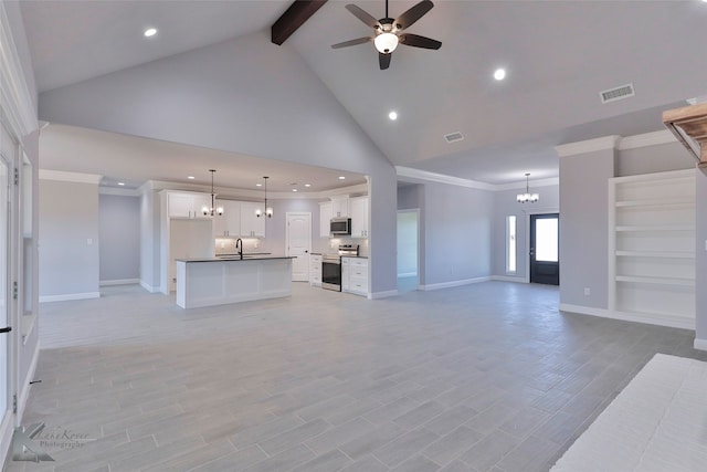 unfurnished living room with light hardwood / wood-style floors, high vaulted ceiling, ceiling fan with notable chandelier, ornamental molding, and sink